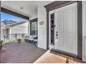 Inviting covered front porch with seating area, decorative door, and house number display at 14209 Lake Live Oak Dr, Orlando, FL 32828