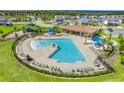 Aerial view of a resort-style pool with a covered pavilion, lounge chairs, and playground at 14315 Crestavista Ave, Clermont, FL 34714