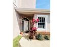 Inviting front entryway with colorful plants and brick accents at 14339 Windchime Ln, Orlando, FL 32837