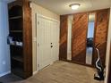 Welcoming entryway with tile flooring, wood accent wall and built-in shelving at 162 Lago Vista Blvd, Casselberry, FL 32707