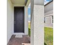 Front door of home with brick pavers and neutral colored stucco at 16450 Bird Of Paradise Ave, Clermont, FL 34714