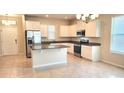 Bright open kitchen featuring an island, granite counters, stainless appliances, and ample cabinet space at 16749 Harper Cove Dr, Winter Garden, FL 34787