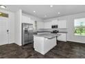Modern kitchen with white cabinets, granite countertops, and stainless steel appliances at 16749 Harper Cove Dr, Winter Garden, FL 34787