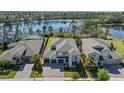 Stunning aerial view of a two-story home with lake views and beautifully maintained landscaping at 16975 Wingspread Loop, Winter Garden, FL 34787