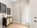 Inviting entryway features a stylish cabinet, artistic wall decor, and tile flooring at 2005 E Grant Ave, Orlando, FL 32806
