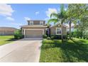 Attractive home with a spacious driveway, a two-car garage, and a manicured front yard, exuding warmth at 2319 Grantham Ave, Davenport, FL 33837