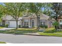 Inviting one-story home with a well manicured lawn and attached garage at 2867 Oconnell Dr, Kissimmee, FL 34741