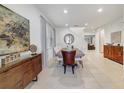 Elegant dining room with a large table, modern decor, and tile flooring at 310 Pendant Ct, Kissimmee, FL 34747