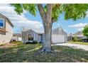 Suburban home with mature trees, green lawn, and a two-car garage at 413 Mainsail Ct, Lake Mary, FL 32746