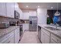 Contemporary kitchen featuring white cabinets, granite countertops, and stainless steel appliances at 4166 Lana Ave, Davenport, FL 33897