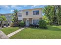 Two-story home featuring a green lawn and mature landscaping at 464 Green Spring Cir, Winter Springs, FL 32708