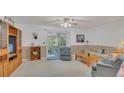 Cozy living room with sliding glass doors and neutral carpeting at 464 Green Spring Cir, Winter Springs, FL 32708