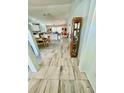 Hallway view showcasing tile flooring and an open floor plan leading to the kitchen at 6037 Hickory Grove Ln, Port Orange, FL 32128