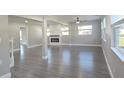 Bright, open living room featuring modern gray flooring, fireplace, and neutral paint at 604 Missouri Ave, St Cloud, FL 34769