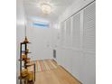 Inviting entryway with wood floors, closet space, and decorative shelving at 700 Melrose Ave # L-23, Winter Park, FL 32789