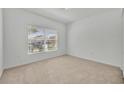 Well-lit, empty bedroom with neutral carpet and a large window bringing in natural light at 7219 Rafanelli Ct, Orlando, FL 32818