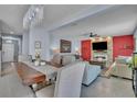 Elegant living room with a stone fireplace, TV, and neutral-toned furniture at 9401 La Salle St, Groveland, FL 34736