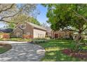 Stunning home with a circular driveway, lush landscaping and stone accents at 9548 Crown Prince Ln, Windermere, FL 34786