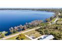 Scenic aerial view showing a home near a tranquil lake at 11800 Buttonhook Dr, Clermont, FL 34711