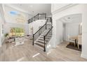 Bright and spacious entryway with soaring ceilings, modern staircase, and elegant chandelier lighting at 1185 Cypress Loft Pl, Lake Mary, FL 32746