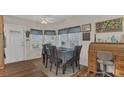 Bright dining area with wood floors, a ceiling fan, and a charming window at 1408 Schult Ct, Tavares, FL 32778