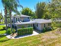 Charming two-story home featuring a teal door, landscaped front yard, and rooftop deck at 1519 N Westmoreland Dr, Orlando, FL 32804