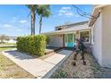 A home featuring a teal door, landscaped front yard, and a well-maintained walkway at 1519 N Westmoreland Dr, Orlando, FL 32804