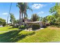 A home's landscaped front yard showcasing its lush green lawn and tropical palm trees at 1519 N Westmoreland Dr, Orlando, FL 32804