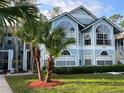 Charming light blue two-story house with lush green lawn and landscaped yard at 2020 Royal Bay Blvd # 92, Kissimmee, FL 34746