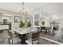 Elegant dining area featuring a modern table set, stylish chandelier, and decorative wall art at 2202 Clubside Dr # 2202, Longwood, FL 32779