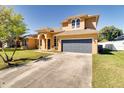 Two-story home with a two-car garage and a well-maintained lawn at 2238 Amberly Ave, Orlando, FL 32833