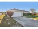 Charming single-story home featuring a wide driveway and an attached two-car garage at 23 Juniper Drive Ct, Ocala, FL 34480