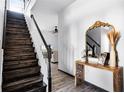 Wooden staircase with white walls, tile floors, and view to the living room at 2606 Teeside Ct, Kissimmee, FL 34746