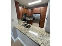 Granite countertops and stainless steel appliances shine in this kitchen space at 2624 Robert Trent Jones Dr # 610, Orlando, FL 32835