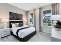 Inviting bedroom with plush carpet, neutral tones, and large windows with neighborhood views at 2761 Redblush Ter, St Cloud, FL 34772