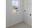 Neat laundry room with a window overlooking the front of the house and car at 3070 Daffodil Dr, Lake Hamilton, FL 33851