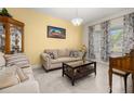 Cozy living room featuring neutral tones, comfortable seating, and natural light at 430 Brunswick Dr, Davenport, FL 33837