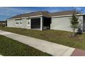 Exterior of the home featuring a screened in porch and a view of the backyard at 5111 Lake Hamlin Trl, Winter Garden, FL 34787