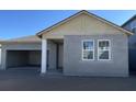 New home exterior featuring attached garage, stucco siding and energy efficient windows and doors at 5738 Cattle Ranch Dr, St Cloud, FL 34771