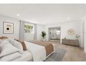 Serene main bedroom with ample natural light, neutral tones, and a seamless transition to the seating area at 6301 Sunshine St, Orlando, FL 32818