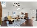 Bright living room features hardwood floors, a ceiling fan, and multiple skylights at 651 Robinhood Dr, Maitland, FL 32751