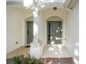 Covered entranceway featuring a concrete floor, olive green doors, and shared support column at 6847 Sperone St, Orlando, FL 32819