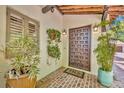 Inviting entryway features a detailed wooden door, brick pathway, and decorative plants, creating a warm welcome at 851 Georgia Ave, Winter Park, FL 32789