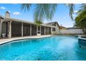 Sparkling swimming pool and screened lanai, perfect for outdoor living at 8520 Rose Groves Rd, Orlando, FL 32818