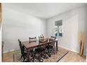 Bright dining room with a dark wood table, six chairs, and natural light at 885 Carmillion Ct, Groveland, FL 34736