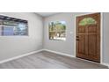 Bright entryway showcasing wood-look flooring, a window, and a classic wooden front door at 912 Citrus St, Orlando, FL 32805