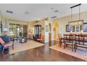 Open-concept living area with hardwood floors, stylish furnishings, and sliding glass doors to the outdoor space at 10027 Hart Branch Cir, Orlando, FL 32832