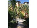Charming community playground area featuring a sandbox and mature shade trees at 12544 Floridays Resort Dr # 103B, Orlando, FL 32821
