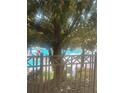 Relaxing poolside view with a glimpse of the sparkling pool through the trees at 12544 Floridays Resort Dr # 103B, Orlando, FL 32821