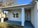 Welcoming entrance with modern door, sturdy pillars, and a cozy porch area, perfect for relaxing at 137 W G H Washington St, Apopka, FL 32703